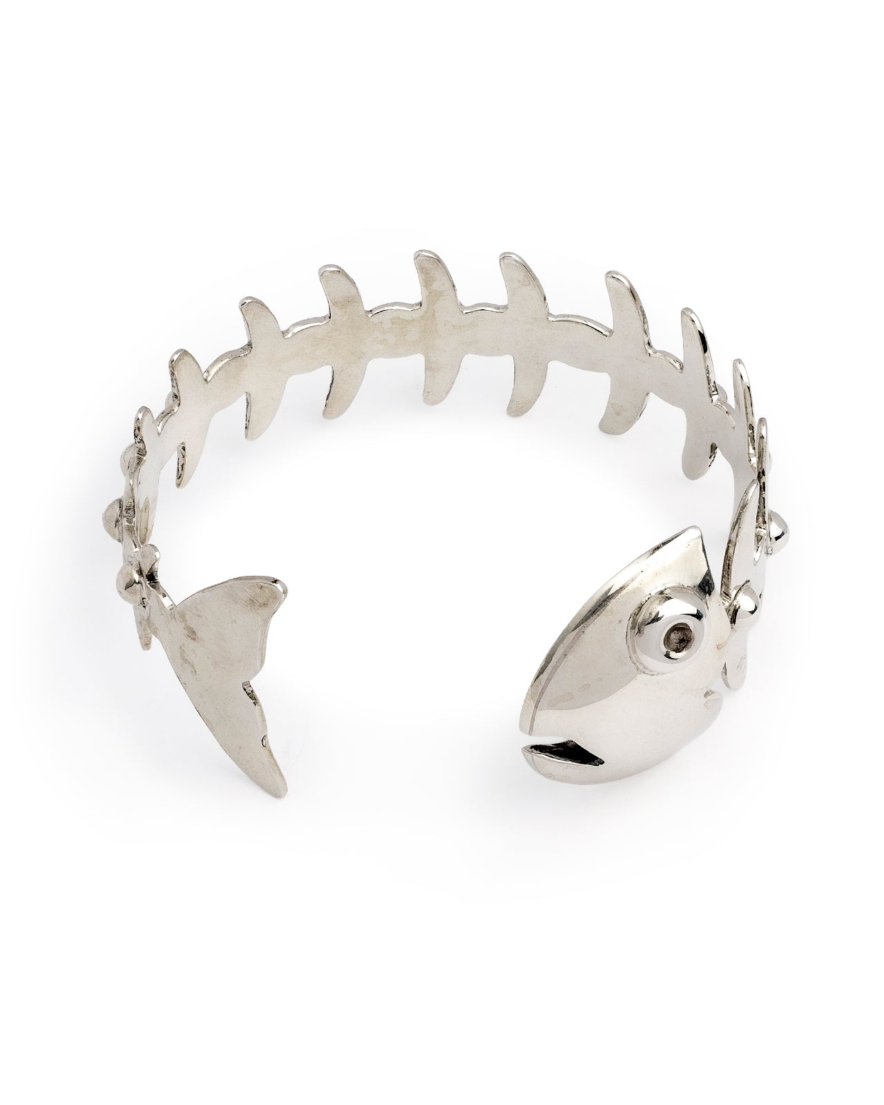 A silver cuff bracelet designed like a fish skeleton, featuring a fish head and tail detail on the ends, photographed on a clean white background.