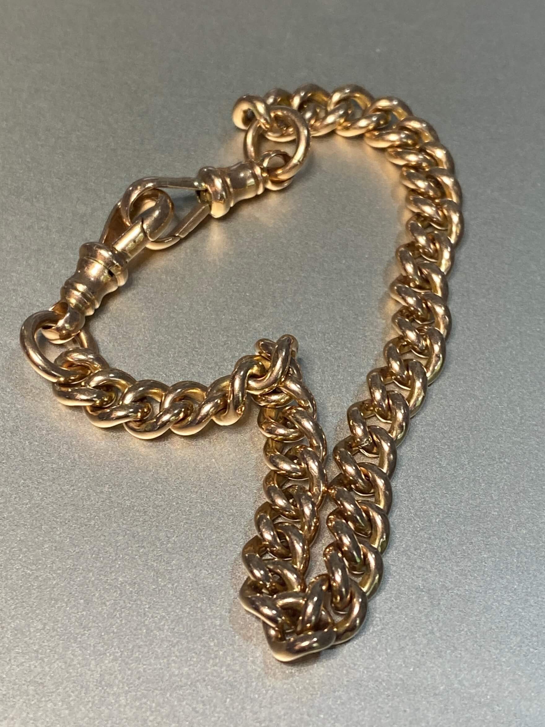 Antique 9ct Rose Gold Bracelet, of classic curb link design, and hung with two antique swivels. 9ct rose gold. 18.09 grams