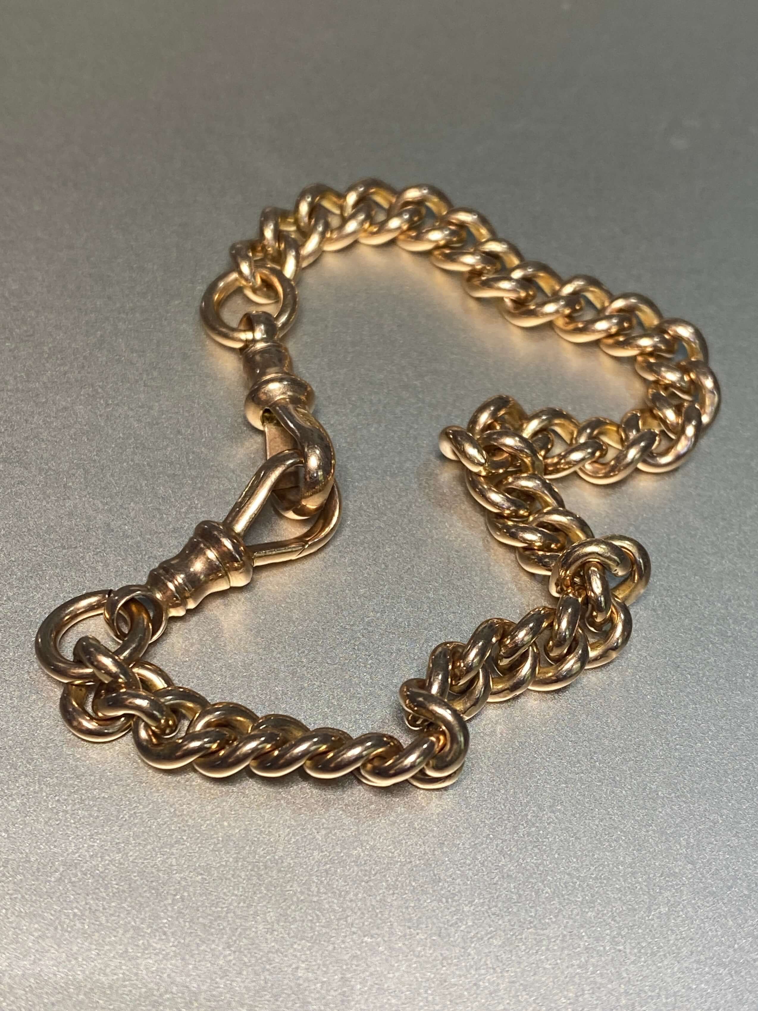 Antique 9ct Rose Gold Bracelet, of classic curb link design, and hung with two antique swivels. 9ct rose gold. 18.09 grams