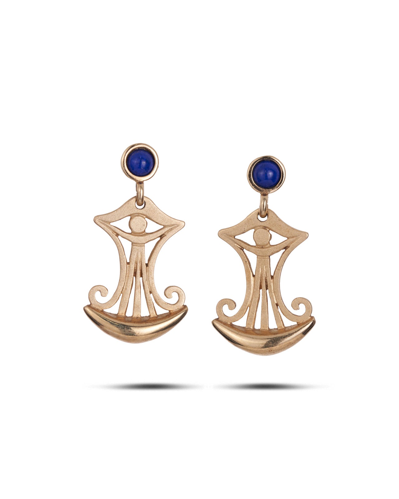 A pair of gold-toned dangle earrings with a stylized eye-of-providence motif, featuring a small round blue stone at the top and a crescent-shaped lower section, shown on a white background.