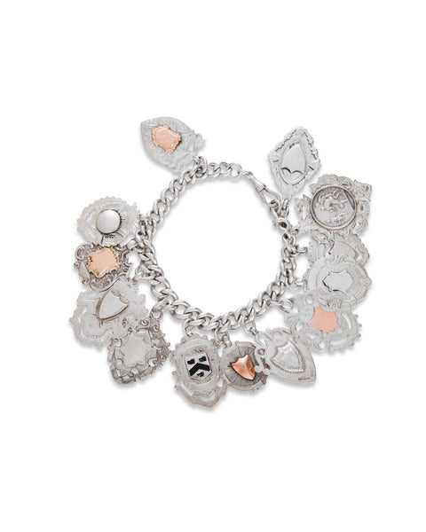 Edwardian Era Serling Silver Fob Charm Bracelet. The curb link bracelet hung with thirteen various silver fobs and a swivel clasp.
