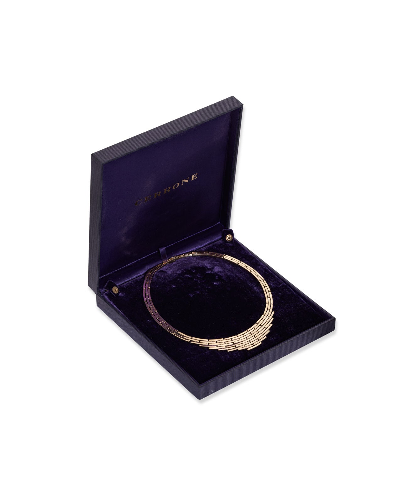 A gold-toned woven necklace displayed inside an open dark purple velvet jewelry box with the brand name 'CERRONE' printed on the inside lid, set against a plain white background.
