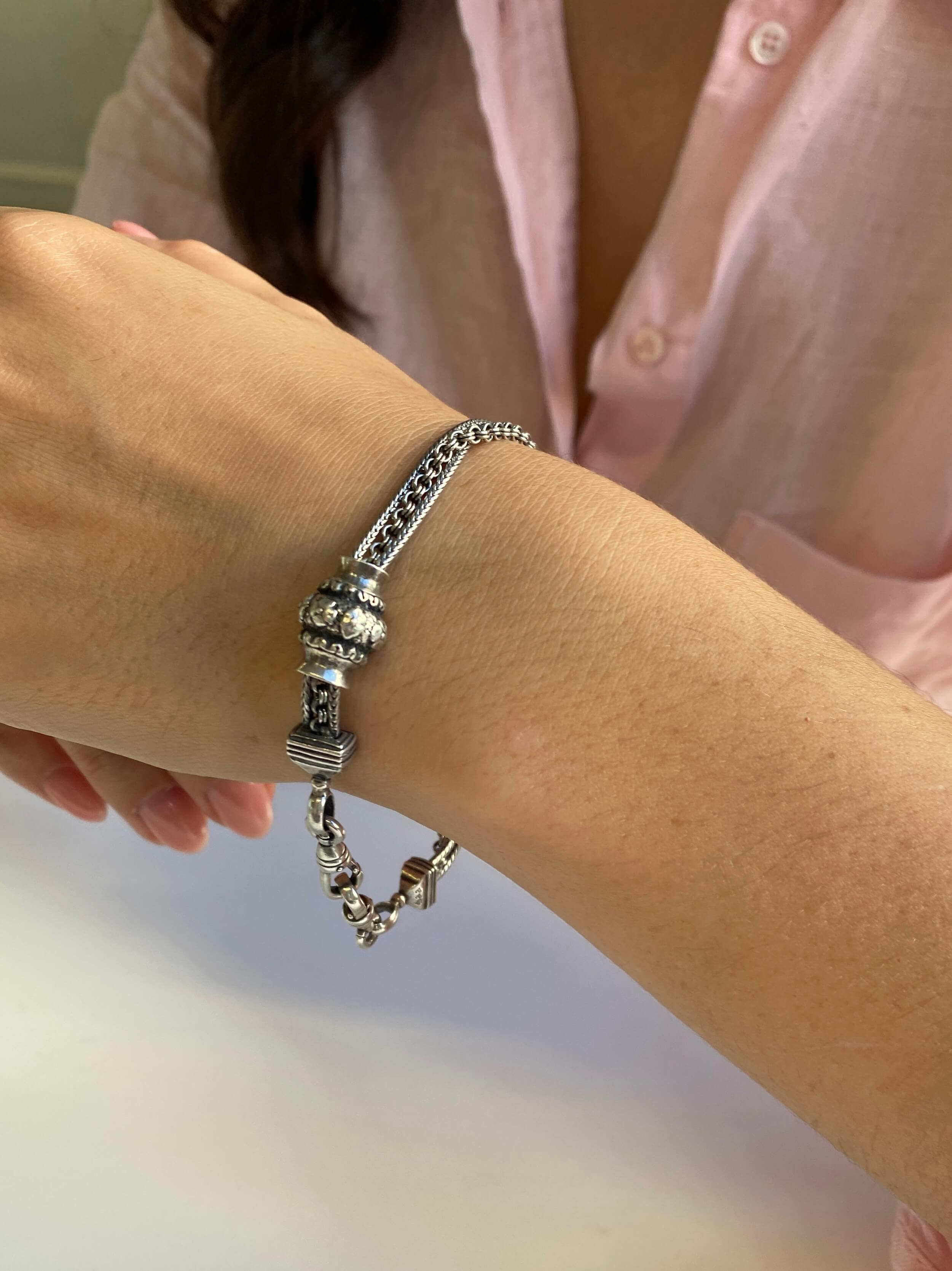 Antique Style Silver Albertina Bracelet, of triple strand design, and hung with two swivel catches and barrel shaped slide with floral decoration.