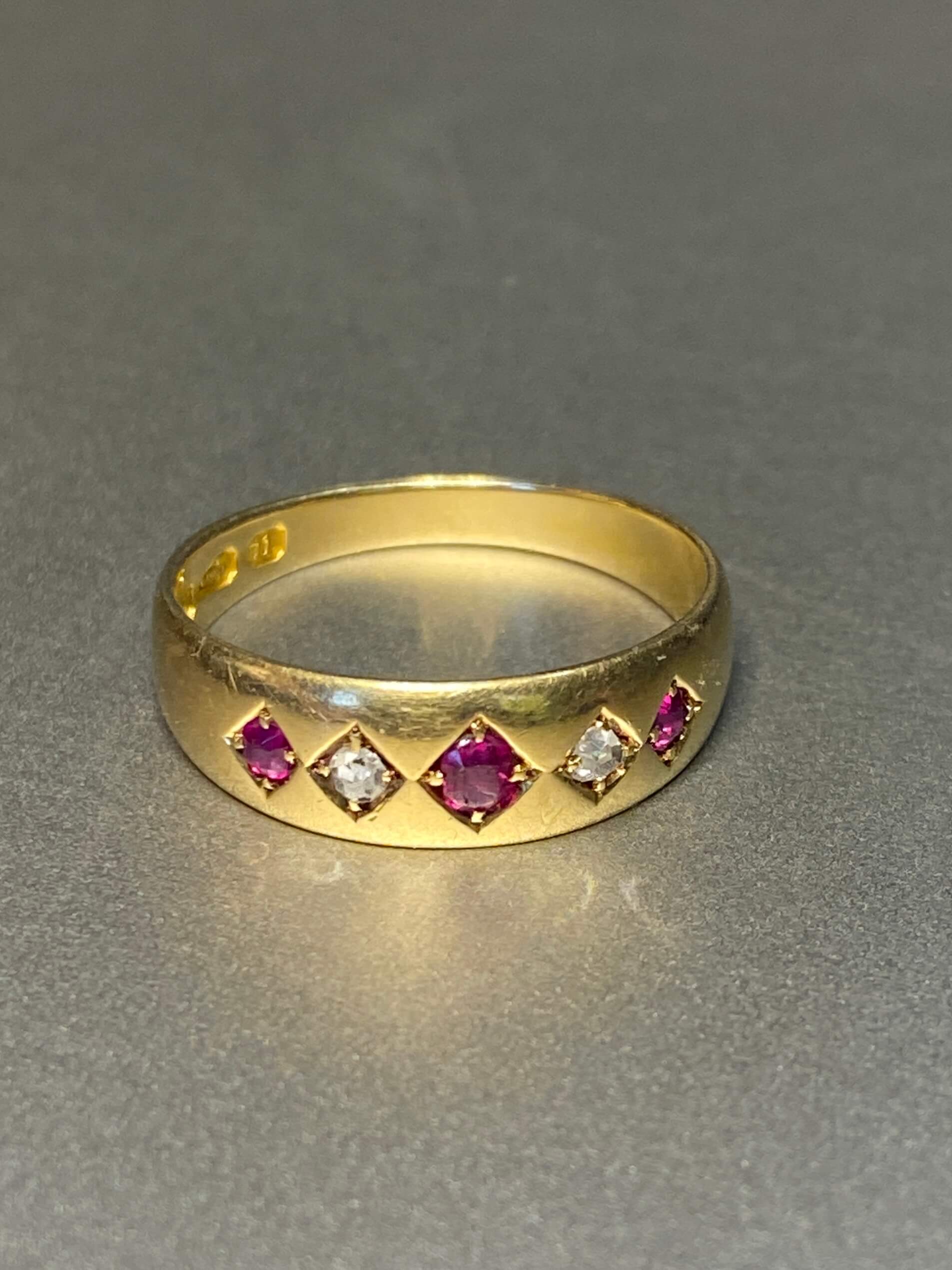 Antique Ruby & Diamond Gypsy Ring. A traditional late Victorian gypsy ring, flush set with three graduated rubies alternating with two old cut diamonds. 18ct yellow gold.