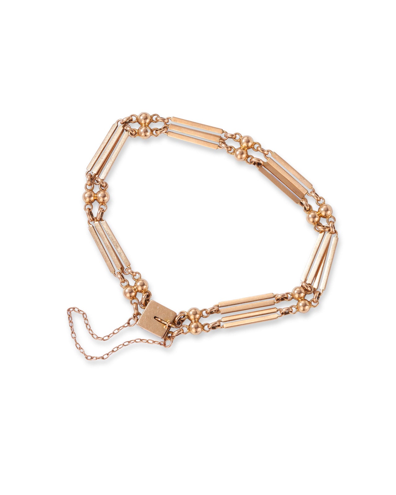 Antique yellow gold double bar gate bracelet on white background