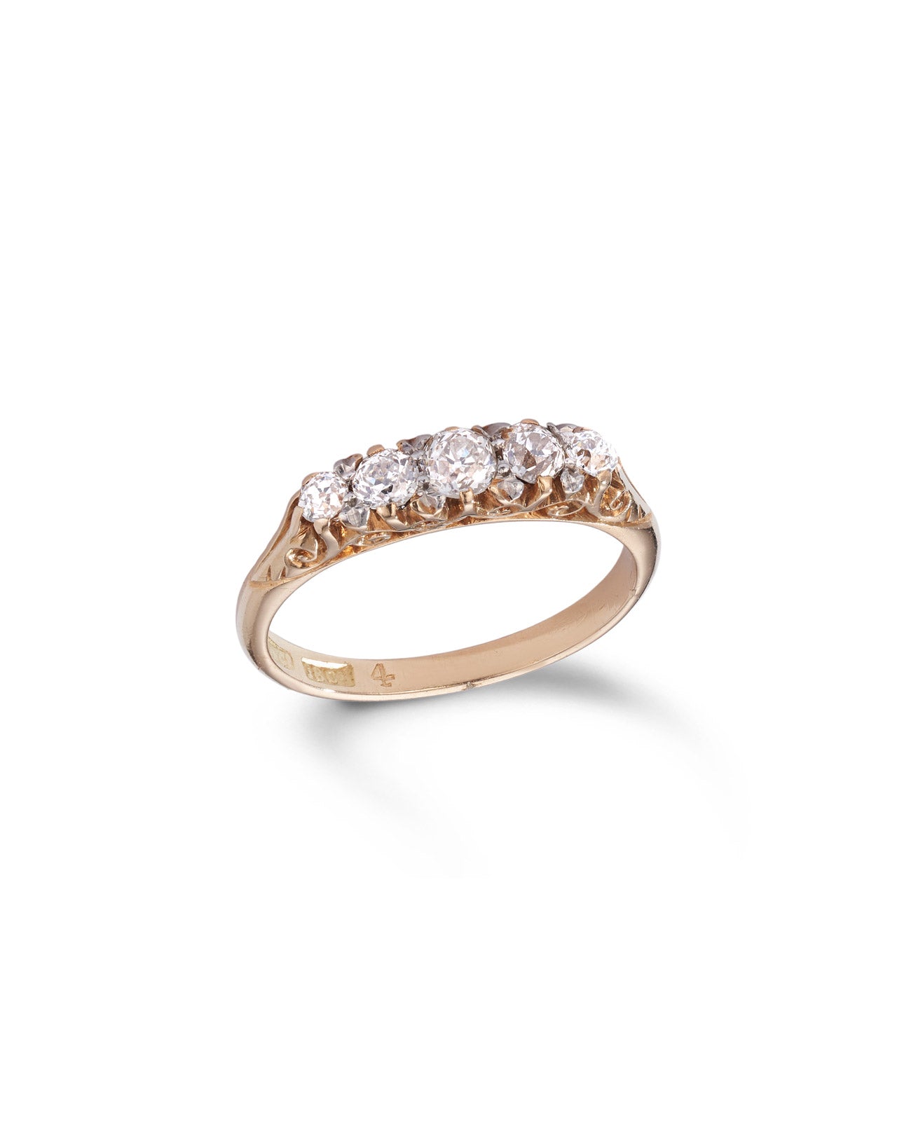 A yellow gold ring featuring a row of five round old cut diamonds shown on a clean white background with a soft shadow.